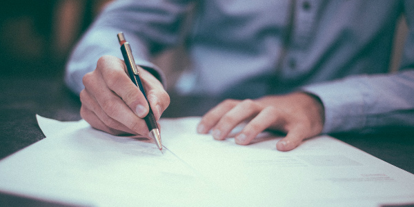 an office employee reads the HR support information Pacific Prime has delivered as part of its leading employee benefits brokering services